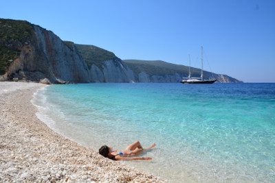 A lady lying at hte fteri beach seaside